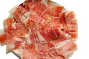 50326068 - iberian ham with a plate of slices of ham. typical spanish